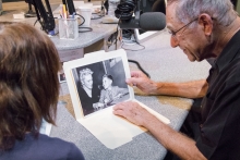 Michael Markson shows Judy Bartlestone a photo with his mom, taken when he was a young boy.